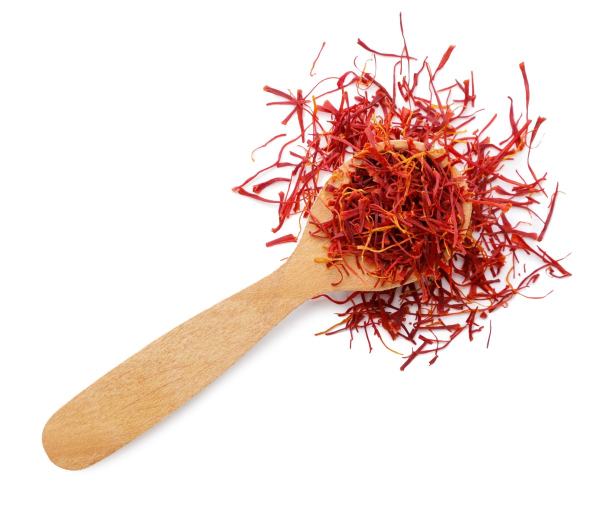 Saffron spice in a wooden spoon close-up on a white background. Top view